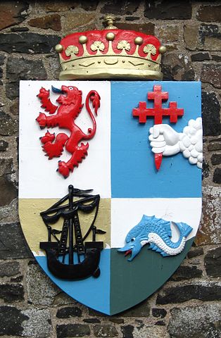 The arms of Clan MacDonnell of Antrim, displayed on Dunluce Castle. Photo by Adam Cuerdon, via Wikimedia Commons.